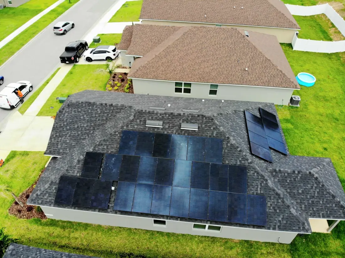 Aerial view of a full rooftop solar array installed on a family home